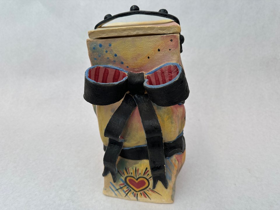 Colorful box constricted by a black bow